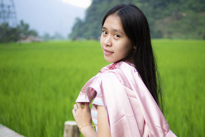 Portrait of woman standing on field