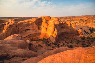 View of rock formations in canyon against cloudy sky