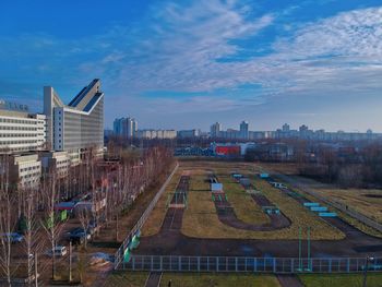 High angle view of road by buildings against sky