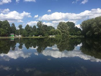 Reflection of trees in lake against sky