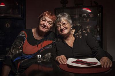 Portrait of smiling woman sitting on table