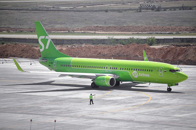 High angle view of airplane on airport runway