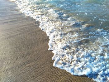High angle view of waves rushing towards shore