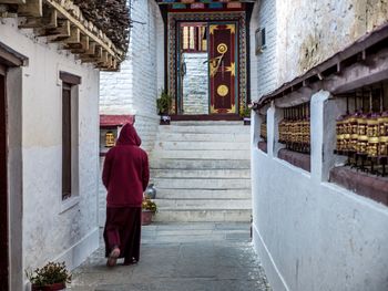 Rear view of a monk walking in temple