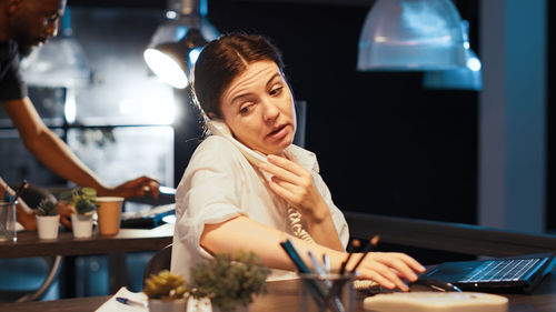 Portrait of young woman working in cafe