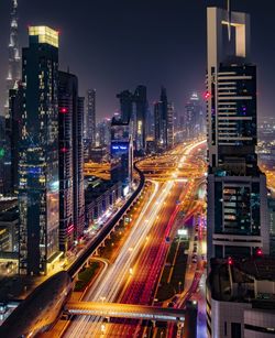 High angle view of illuminated city street and buildings at night