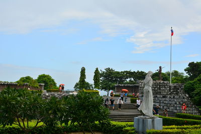 View of statues against cloudy sky