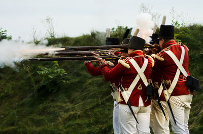 Rear view of men with people in the background