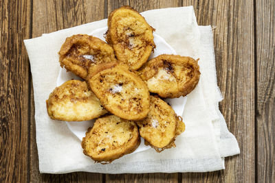 Easter dessert.traditional homemade spanish french toast on wooden background. top view