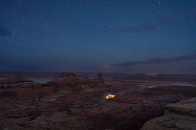 Scenic view of landscape against sky at night