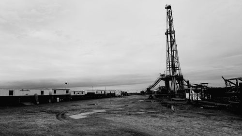 Crane on shore against sky