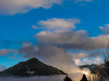 Scenic view of mountains against cloudy sky