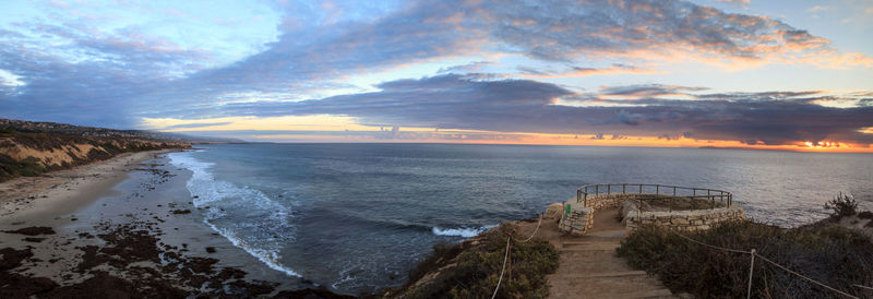 Scenic view of beach against sky during sunset