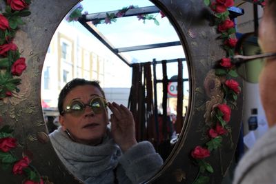 Portrait of woman with reflection in mirror