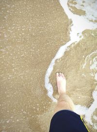 Low section of people standing on tiled floor