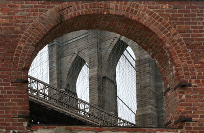 Low angle view of arched brick wall