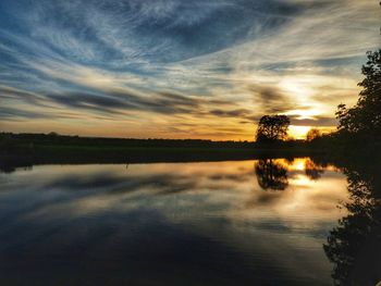 Scenic view of lake against sky during sunset