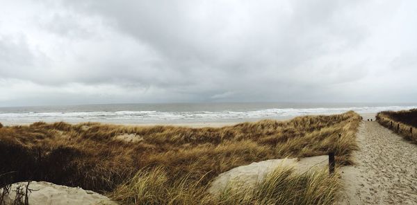 Scenic view of sea against cloudy sky