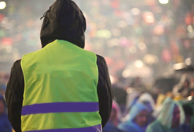 Rear view of people standing outdoors