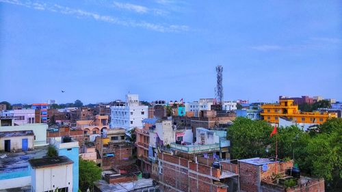 High angle view of buildings against blue sky