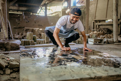 Side view of man standing on puddle