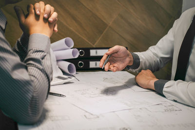 High angle view of people working on table