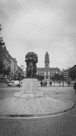 Statue in city against clear sky