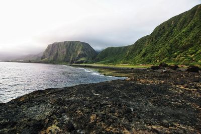 Scenic view of mountains and sea against sky