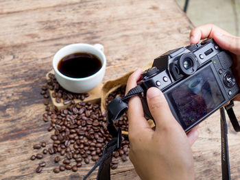 High angle view of hand holding coffee cup