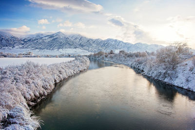 Scenic view of river through frosted landscape