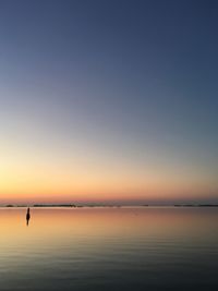 Scenic view of sea against clear sky during sunset