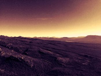 Scenic view of field against clear sky during sunset