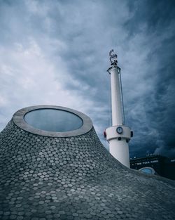 Low angle view of building against cloudy sky