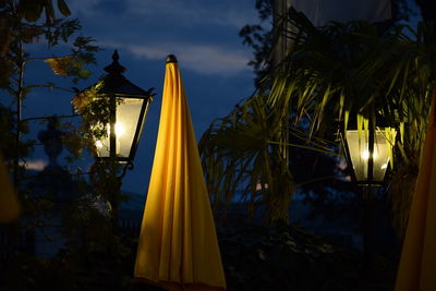 Low angle view of illuminated lantern against sky at night