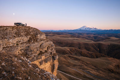 Rock formations on landscape against sky during sunset