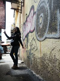 Full length of woman on wall in city