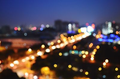 Defocused image of illuminated city at night