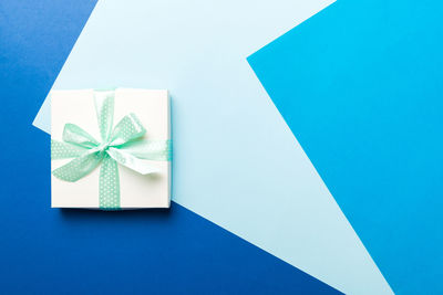 High angle view of gift on blue background