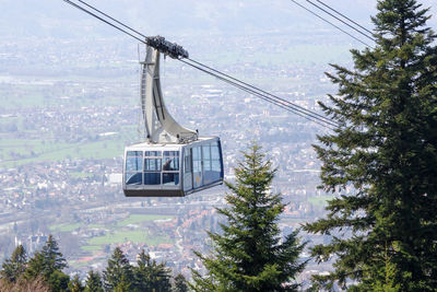 Low angle view of overhead cable car against sky