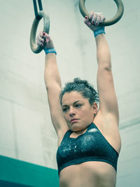 Low angle view of woman exercising in gym