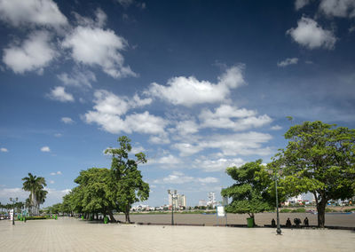 People at beach against sky