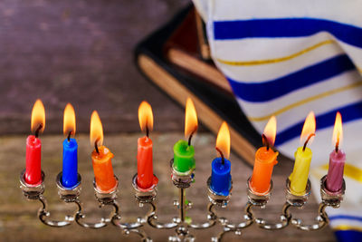 High angle view of colorful candles burning on table