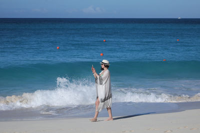 Man standing on beach against sky