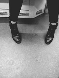 Low section of woman standing on tiled floor