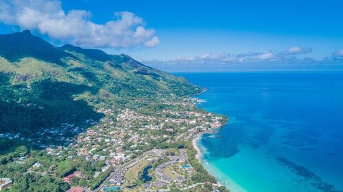 Aerial view of sea against blue sky