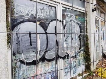 Graffiti on wall seen through glass window