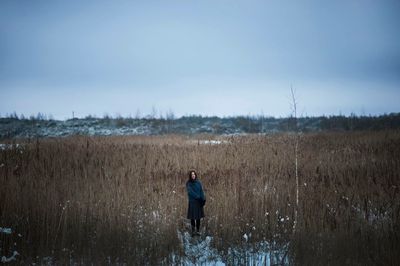Man working on agricultural field against sky