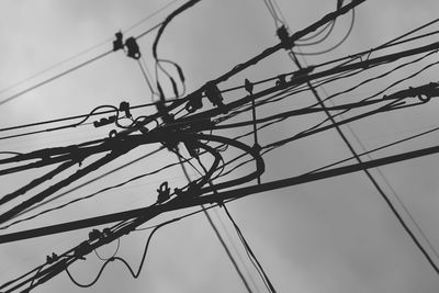 Low angle view of power cables against clear sky