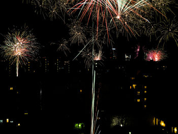 Low angle view of firework display at night