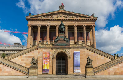 Low angle view of historical building against cloudy sky